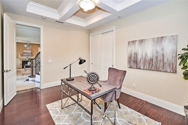 office space with coffered ceiling, baseboards, and wood finished floors