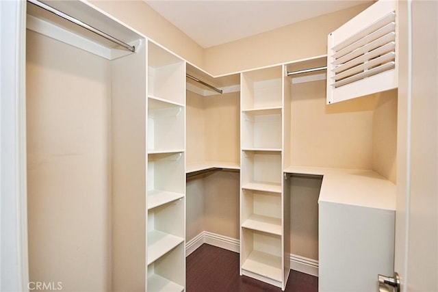 walk in closet featuring dark wood-type flooring