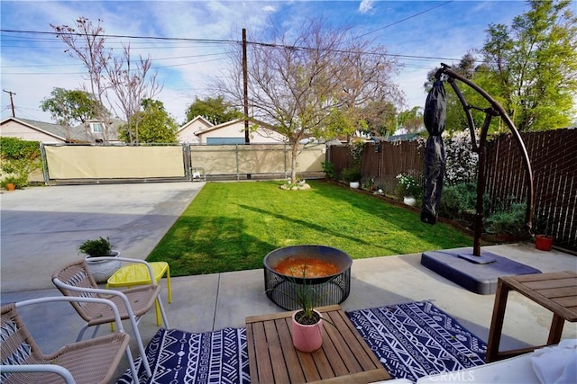 view of yard with an outdoor fire pit, a fenced backyard, a gate, and a patio