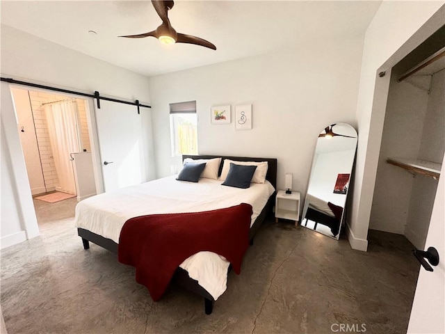 bedroom featuring concrete flooring, a ceiling fan, and a barn door