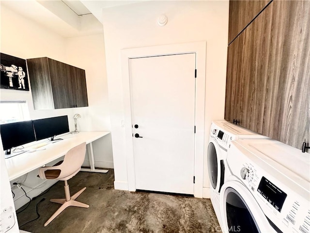 office with baseboards, unfinished concrete flooring, and washing machine and clothes dryer