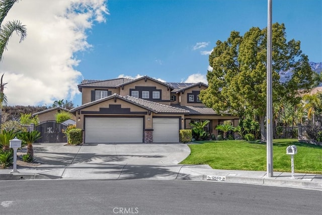 view of front of house with an attached garage, solar panels, a gate, stucco siding, and a front yard