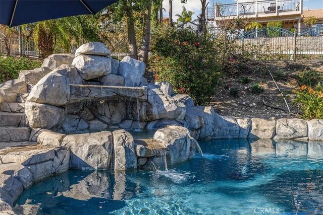 view of pool featuring fence