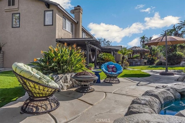 view of patio / terrace with a fire pit and a pergola