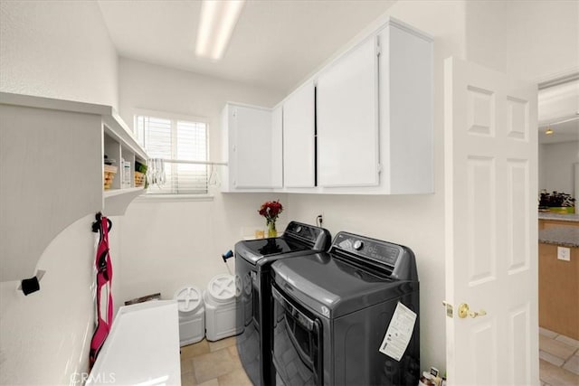 washroom featuring cabinet space and separate washer and dryer