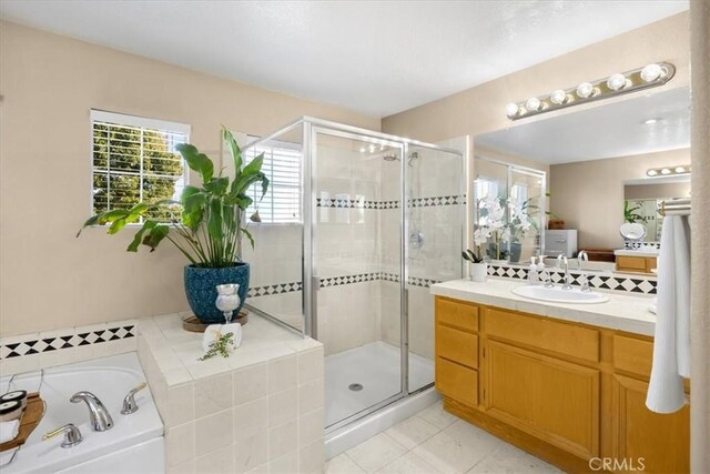 bathroom featuring a garden tub, a shower stall, and vanity