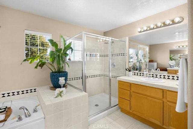 full bath featuring vanity, a garden tub, a shower stall, and tile patterned flooring