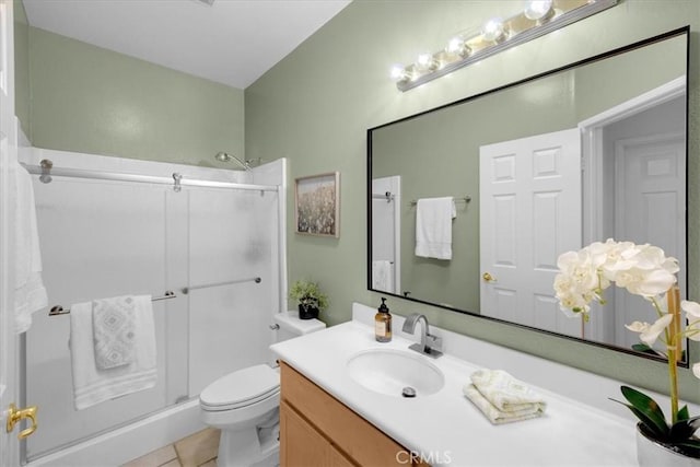 full bathroom featuring toilet, tile patterned flooring, vanity, and a shower with shower door