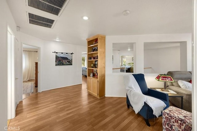 sitting room featuring recessed lighting, visible vents, and wood finished floors