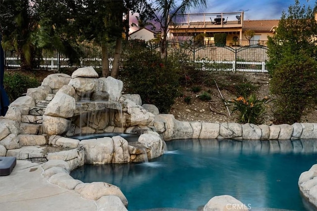 view of pool with a fenced in pool and fence