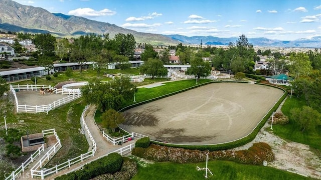 view of community with an enclosed area and a mountain view