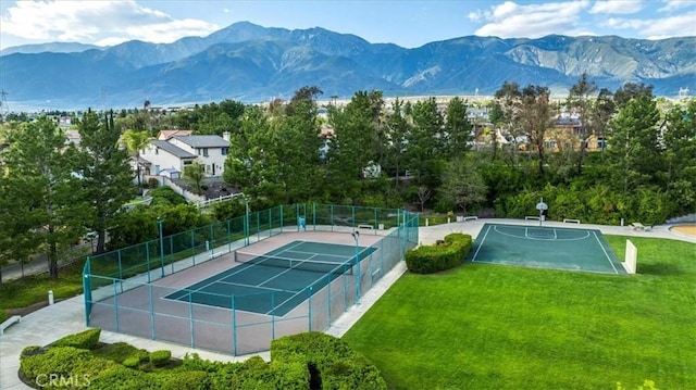 exterior space with a yard, fence, and a mountain view