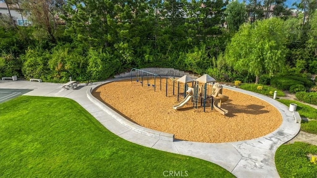 view of community featuring playground community and a yard