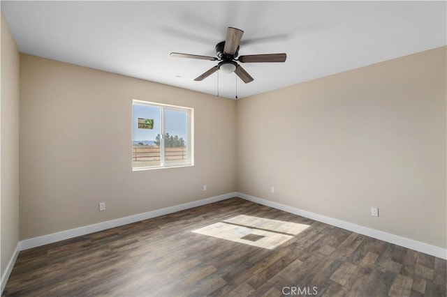 spare room with ceiling fan, wood finished floors, and baseboards