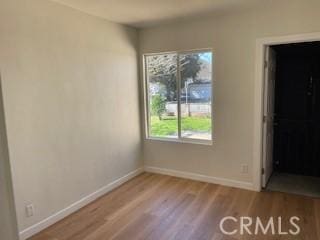 unfurnished bedroom featuring baseboards and wood finished floors