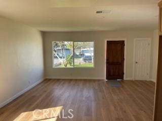 interior space with wood finished floors and baseboards