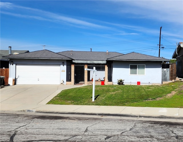 view of front facade featuring stucco siding, concrete driveway, an attached garage, a front yard, and fence