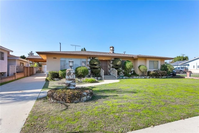 ranch-style house featuring concrete driveway, a front lawn, fence, and stucco siding