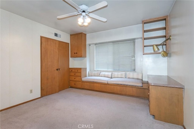 unfurnished bedroom featuring ceiling fan, visible vents, a closet, and light colored carpet