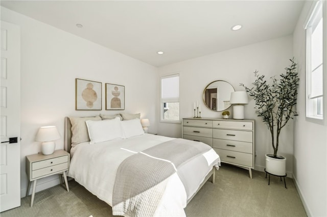 bedroom featuring recessed lighting, light colored carpet, and baseboards