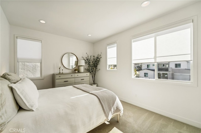 carpeted bedroom featuring recessed lighting and baseboards