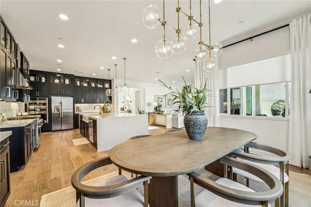 dining area featuring recessed lighting and light wood finished floors