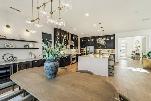 dining area featuring light wood-style flooring, visible vents, and recessed lighting