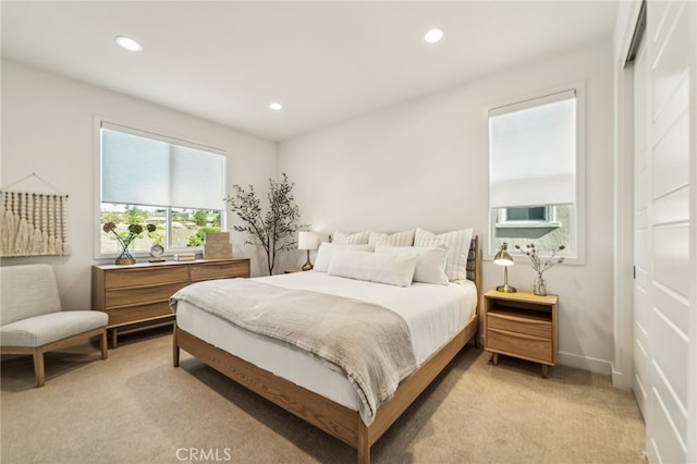 bedroom featuring light carpet, baseboards, and recessed lighting