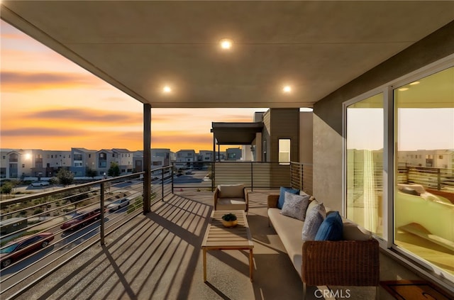 balcony at dusk with a residential view and an outdoor living space