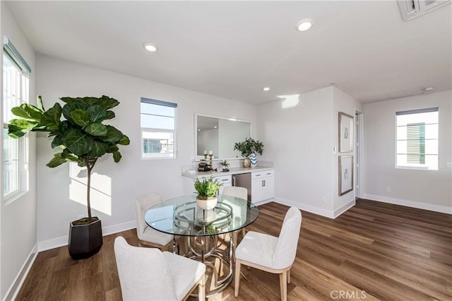 dining space featuring plenty of natural light, wood finished floors, and visible vents