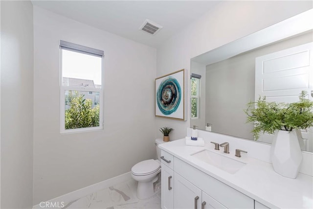 bathroom with baseboards, visible vents, toilet, marble finish floor, and vanity