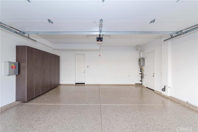 garage with electric panel, baseboards, and a garage door opener