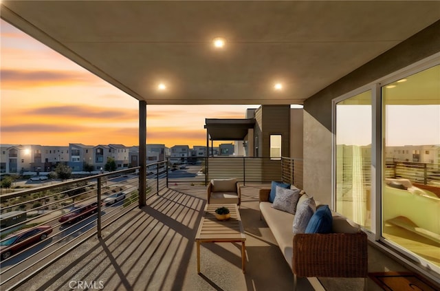 balcony at dusk featuring a residential view and outdoor lounge area