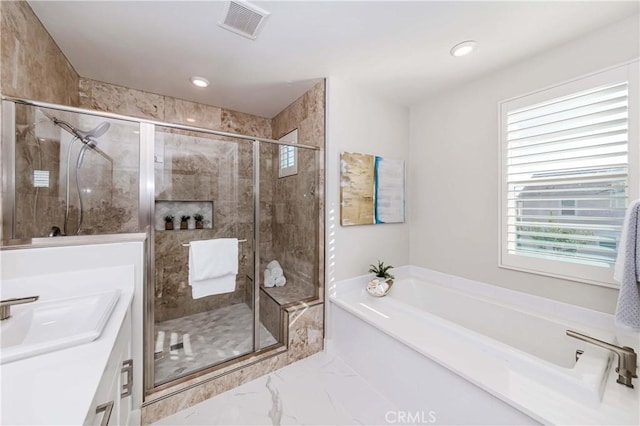 bathroom featuring marble finish floor, visible vents, a garden tub, and a shower stall