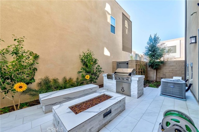 view of patio / terrace featuring a fire pit, area for grilling, a grill, fence, and central air condition unit