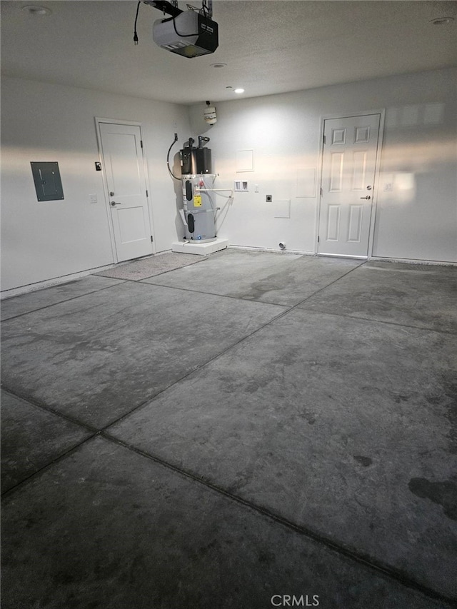 garage featuring electric panel, water heater, and a garage door opener