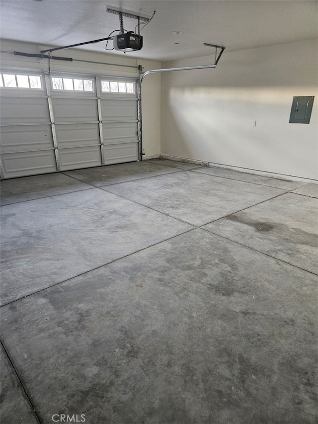 garage with a garage door opener and electric panel