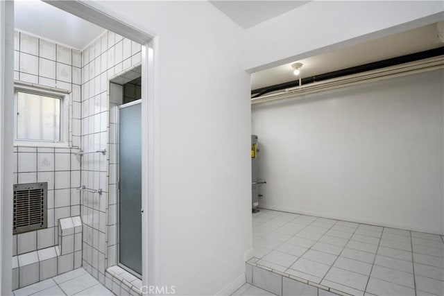 bathroom with a stall shower and tile patterned flooring