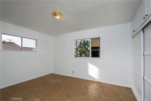 empty room featuring baseboards