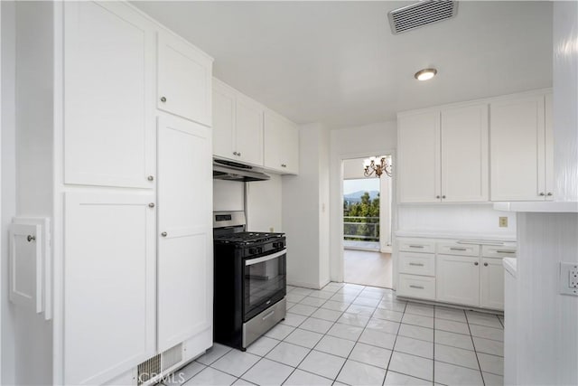 kitchen with visible vents, white cabinets, stainless steel range with gas stovetop, and under cabinet range hood