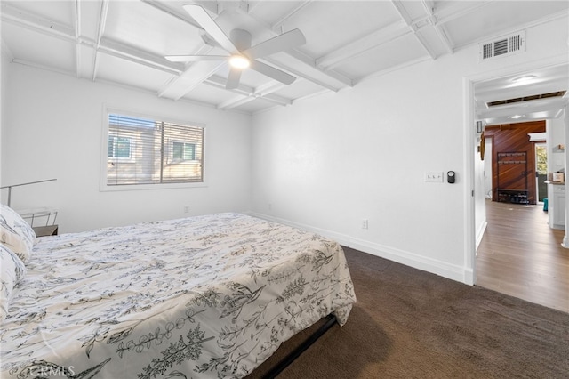 bedroom featuring beam ceiling, coffered ceiling, visible vents, and baseboards