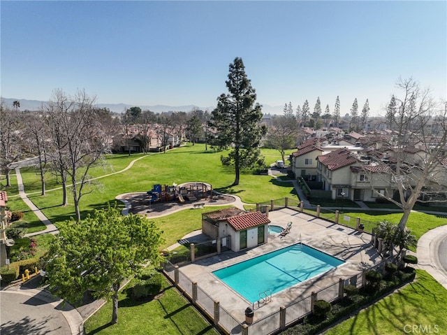 pool with a yard, a patio, fence, and a residential view