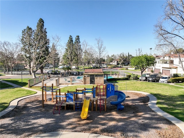 communal playground featuring a yard