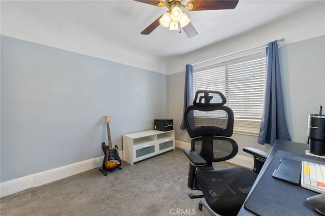 carpeted home office with a ceiling fan and baseboards