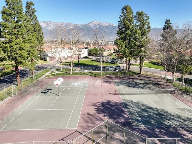 view of sport court with community basketball court, fence, and a mountain view