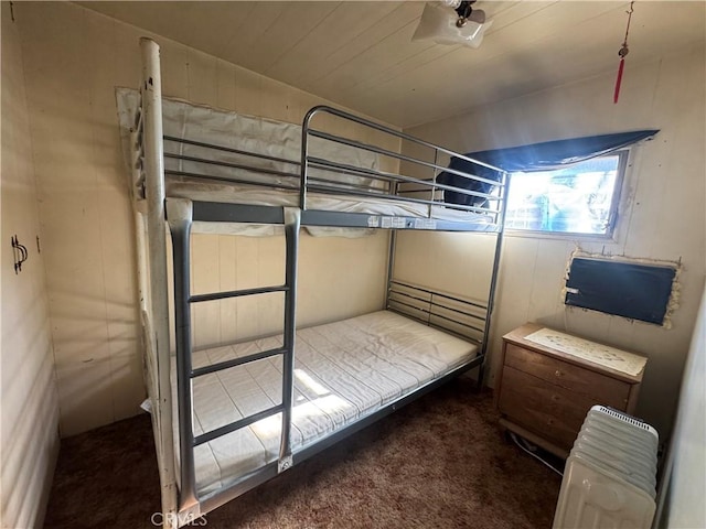 unfurnished bedroom with radiator and carpet flooring