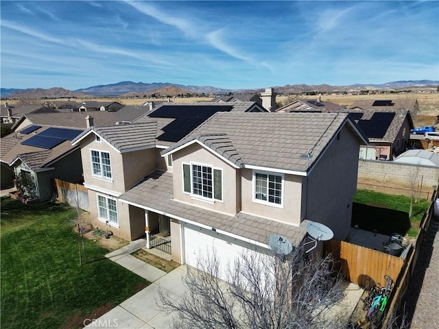 exterior space featuring a mountain view, fence, and stucco siding