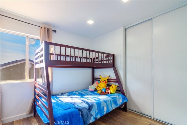 bedroom with a closet and wood finished floors