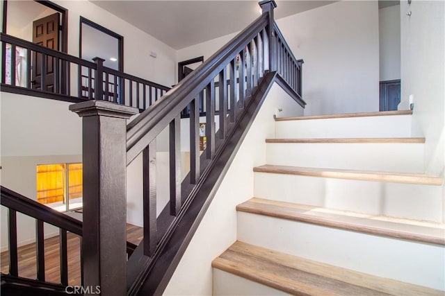 stairway featuring wood finished floors