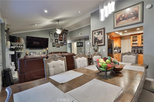 dining space featuring recessed lighting, ceiling fan with notable chandelier, visible vents, vaulted ceiling, and ornamental molding